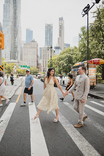 Newly married couple crossing near New York City Hall after their ceremony.